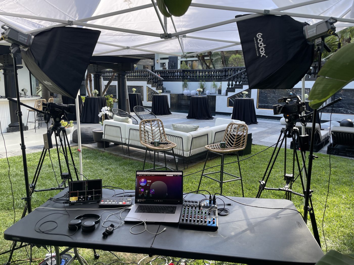 Multi-camera outdoor lounge interview setup at a poolside event